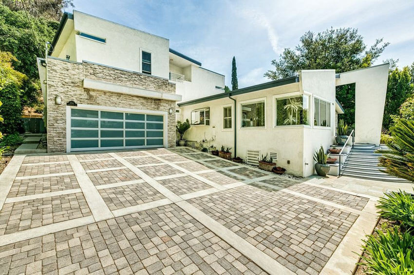 Modern Driveway Paver Green Modern Driveway Put concrete circular driveway at high-end house High-end house with circular driveway Pavers driveway at luxury house Paver driveway in front of house Slate stone pavers driveway at high-end house Brick driveway to house with waterside views Modern concrete driveway Modern house with concrete driveway Asphalt and concrete driveway at modern home Gravel driveway at English countryside home Loose gravel driveway at nation house Curved gravel driveway style at modern house Modern pattern driveway in front of house